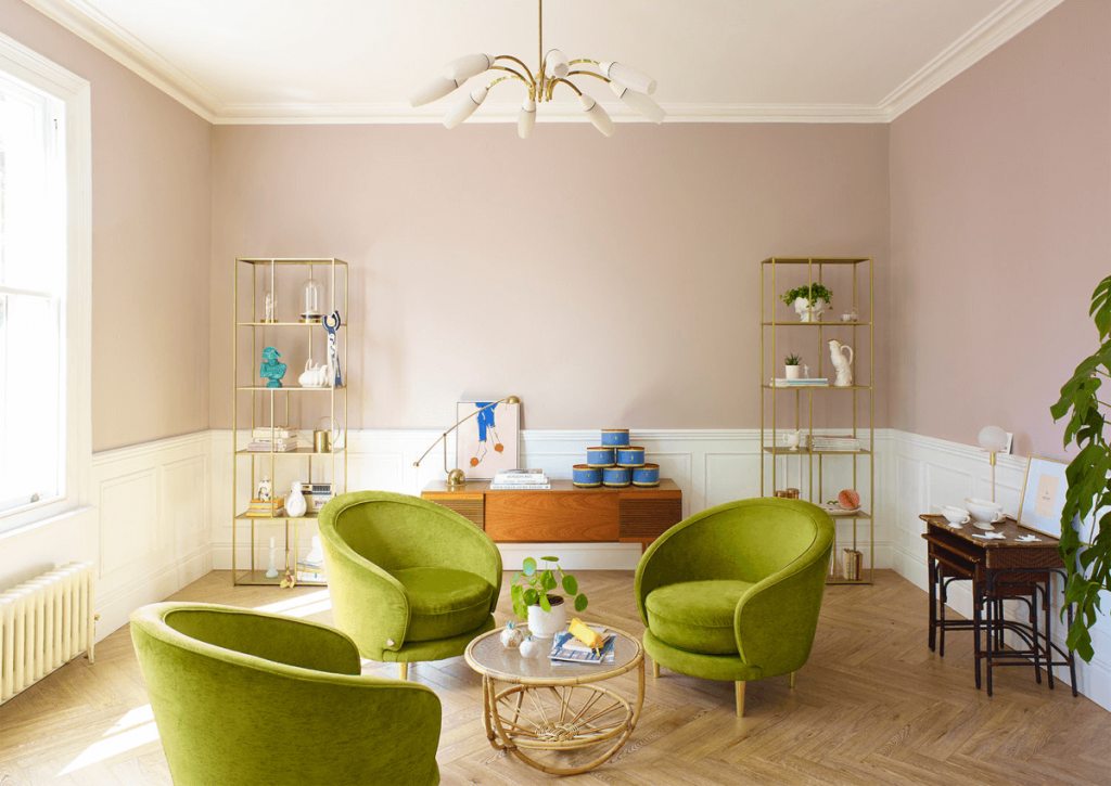 Colourful living room with green chairs and pink walls